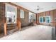 Open concept living room with brick accents, wood paneling, and steps to another level at 33 Elliott Ct, Walterboro, SC 29488
