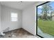 Bright room with exterior access, offering vinyl-look flooring, white paneled walls, and natural light at 33 Elliott Ct, Walterboro, SC 29488