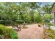 Private backyard featuring a brick patio, lush landscaping, and a tranquil fountain at 344 Lantana Dr, Charleston, SC 29407