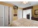 Inviting bedroom featuring a plush, patterned quilt, a ceiling fan, and a wall-mounted television at 344 Lantana Dr, Charleston, SC 29407