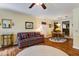 Warm living room featuring wood floors, cozy furniture, and seamless flow into the dining area at 344 Lantana Dr, Charleston, SC 29407
