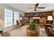 Living room featuring a brick fireplace, ceiling fan, and access to the outdoors at 344 Lantana Dr, Charleston, SC 29407