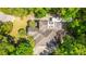 Aerial view of lush, tree-lined property featuring outdoor deck with Adirondack chairs, RV, and circular driveway at 3738 Station Point Ct, Mount Pleasant, SC 29466