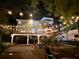 Exterior night view of backyard with overhead lighting, brick patio, and parking at 3738 Station Point Ct, Mount Pleasant, SC 29466