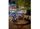 Beautiful backyard at night with string lights, a brick patio, a firepit, and outdoor furniture at 3738 Station Point Ct, Mount Pleasant, SC 29466