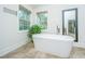 Bright bathroom with a freestanding tub, tile floors, and large windows at 3738 Station Point Ct, Mount Pleasant, SC 29466