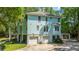 Beautiful light blue two-story home with a two-car garage and balconies surrounded by lush greenery at 3738 Station Point Ct, Mount Pleasant, SC 29466