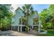 Elegant two-story home with double balconies, surrounded by palm trees, perfect for serene, coastal living at 3738 Station Point Ct, Mount Pleasant, SC 29466