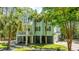 Two-story coastal home featuring a spacious covered carport and upper level balcony, nestled among mature trees at 3738 Station Point Ct, Mount Pleasant, SC 29466