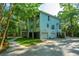 Scenic view of a light blue two-story home with a lush green lawn and concrete driveway at 3738 Station Point Ct, Mount Pleasant, SC 29466