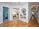 Bright hallway with hardwood floors, transom window, and view into the main bedroom at 3738 Station Point Ct, Mount Pleasant, SC 29466