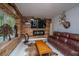 Living room features a rustic wooden accent wall and leather furniture at 3738 Station Point Ct, Mount Pleasant, SC 29466