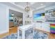 Open concept dining and living space with bright play area with a custom white table at 3738 Station Point Ct, Mount Pleasant, SC 29466