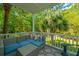 Relaxing porch with comfortable seating, wooded view, and patterned rug at 3738 Station Point Ct, Mount Pleasant, SC 29466