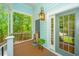 Charming porch with a small fountain and lantern adjacent to the glass-paneled entry door at 3738 Station Point Ct, Mount Pleasant, SC 29466