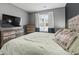 Bedroom with large bed, dresser, television, and window overlooking backyard at 3901 Poplar Grove Pl, Summerville, SC 29483