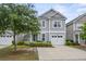 Inviting two-story home with a manicured lawn, attached garage, and attractive curb appeal at 3901 Poplar Grove Pl, Summerville, SC 29483