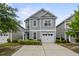 Charming two-story home with gray siding, manicured landscaping, and a private driveway at 3901 Poplar Grove Pl, Summerville, SC 29483