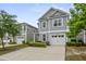 Charming two-story home featuring a well-maintained lawn, attached garage, and neutral siding at 3901 Poplar Grove Pl, Summerville, SC 29483