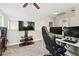 This spacious entertainment room features a ceiling fan, plush carpet, and a large television at 3901 Poplar Grove Pl, Summerville, SC 29483