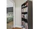 Hallway with a view into a bedroom, featuring a large bookcase and wood floors at 3901 Poplar Grove Pl, Summerville, SC 29483