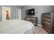 Serene main bedroom with a large bed, a mounted TV, and ample natural light at 3901 Poplar Grove Pl, Summerville, SC 29483