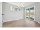 Elegant dining room with modern lighting, hardwood floors, and views of the outdoors at 399 Claret Cup Way, Charleston, SC 29414