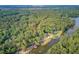 An aerial capture displays the property including the main house and a pool, situated along a river at 4292 Cloudmont Dr, Hollywood, SC 29449