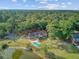 Aerial view of a secluded home surrounded by lush trees and a private pool, situated next to a tranquil lake at 4292 Cloudmont Dr, Hollywood, SC 29449