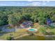 Expansive aerial view showcasing the home's pool, backyard, and waterfront location surrounded by mature trees at 4292 Cloudmont Dr, Hollywood, SC 29449