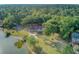 Aerial view of a private property with a pool and waterfront access, enveloped by dense trees at 4292 Cloudmont Dr, Hollywood, SC 29449
