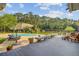 Lovely backyard with a pool, deck, seating, and a scenic view of the lake at 4292 Cloudmont Dr, Hollywood, SC 29449