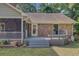 Charming backyard with brick home, screened porch, and spacious deck with seating at 4292 Cloudmont Dr, Hollywood, SC 29449