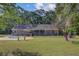 Spacious backyard with a pool, patio, and lush green lawn surrounded by a sleek black fence at 4292 Cloudmont Dr, Hollywood, SC 29449
