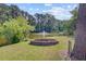 Lush backyard featuring a fire pit with views of a serene lake and fountain at 4292 Cloudmont Dr, Hollywood, SC 29449
