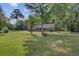 Expansive backyard leading to waterfront with a pool and inviting patio area at 4292 Cloudmont Dr, Hollywood, SC 29449