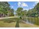 Lush backyard featuring a pool with a serene lake view, perfect for relaxing outdoors at 4292 Cloudmont Dr, Hollywood, SC 29449