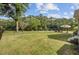 Spacious backyard with lush lawn, mature trees, and waterfront views, ideal for relaxation at 4292 Cloudmont Dr, Hollywood, SC 29449