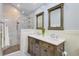 Bathroom featuring double sink vanity and a glass enclosed tile shower at 4292 Cloudmont Dr, Hollywood, SC 29449
