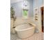 Bathroom featuring a soaking tub, patterned tile floor, and linen cabinet at 4292 Cloudmont Dr, Hollywood, SC 29449