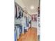 A spacious walk-in closet with custom shelving and wooden floor provides ample storage at 4292 Cloudmont Dr, Hollywood, SC 29449