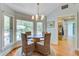 Bright dining nook with backyard views, complemented by stylish wicker chairs and hardwood floors at 4292 Cloudmont Dr, Hollywood, SC 29449