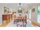 Dining room features hardwood floors, built-in shelves, antique buffet, and modern lighting at 4292 Cloudmont Dr, Hollywood, SC 29449