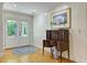 Elegant entryway featuring paneled walls, hardwood floors, and a stylish antique writing desk at 4292 Cloudmont Dr, Hollywood, SC 29449
