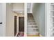Inviting entryway with staircase, dark wood door and patterned rug at 4292 Cloudmont Dr, Hollywood, SC 29449