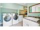 Large laundry room with tile floors, countertops, sink, and modern washer and dryer at 4292 Cloudmont Dr, Hollywood, SC 29449