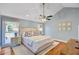 Bedroom with hardwood flooring, ceiling fan, and bright natural light from the windows at 4292 Cloudmont Dr, Hollywood, SC 29449