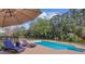 Inviting pool area with comfortable lounge seating, sunshade, and tranquil waterfront view at 4292 Cloudmont Dr, Hollywood, SC 29449