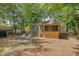 Backyard features mature trees, screened porch, and patio seating at 4546 Holly St, North Charleston, SC 29405