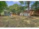 Large, partially shaded backyard features two storage sheds, wooden fence, and covered deck area at 4546 Holly St, North Charleston, SC 29405
